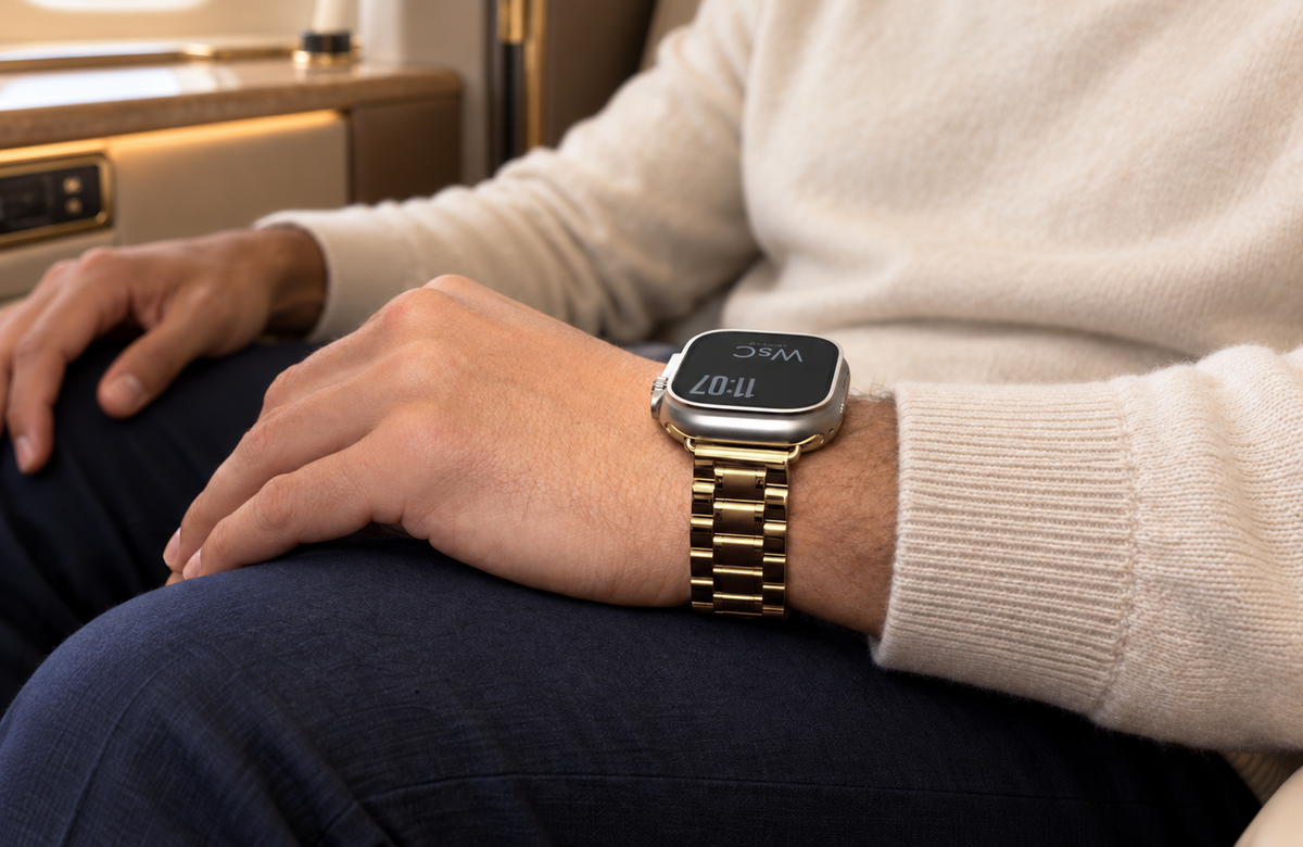 Man wearing the gold WsC Fury Apple Watch strap in a first-class cabin, standard non-diamond