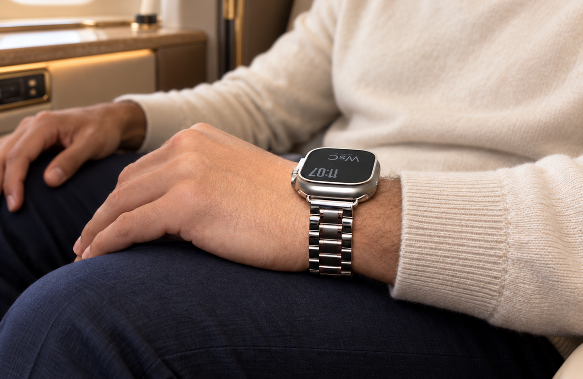 Man wearing the WsC Fury silver and rose gold Apple Watch strap in a first-class cabin, standard edition without diamond