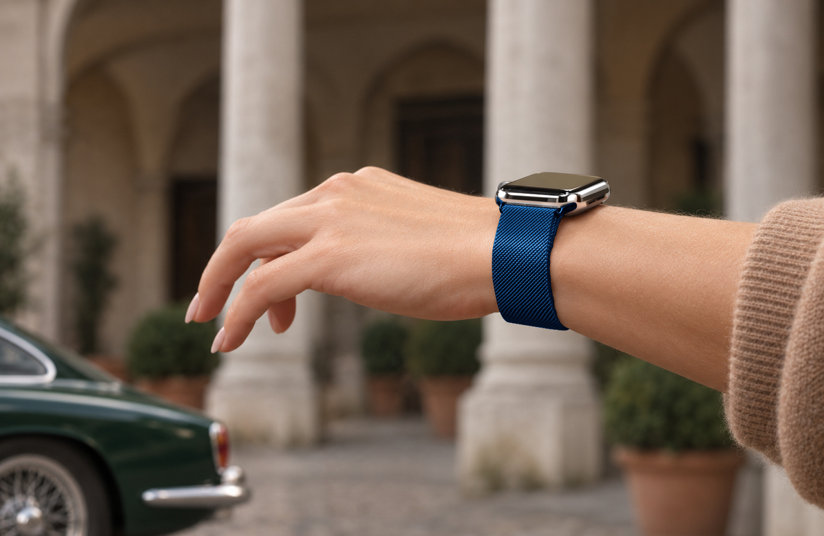 Woman wearing the Cosmic Blue Milanese Loop strap with polished blue connectors and a silver Apple Watch.